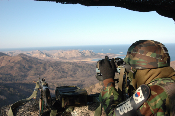 지난달 25일 외금강이 보이는 군사분계선(MDL) 최북단 동부전선 일반전초(GOP)에서 경계병이 쌍안경으로 북측 지역을 감시하고 있다.