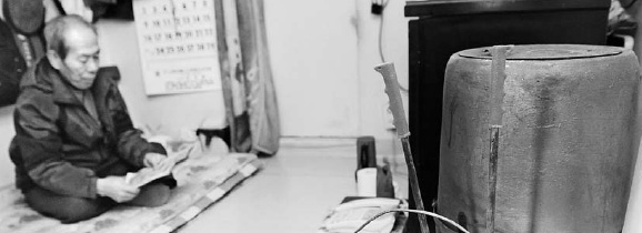 지난 겨울 서울 궁동의 단칸방에서 한 독거 노인이 방안에 연탄난로를 피워 추위를 피하고 있다.   서울신문 포토라이브러리 