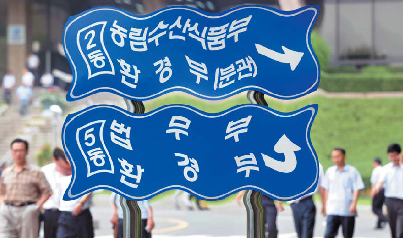1일 정부과천청사에서 공무원들이 점심식사를 하기 위해 청사를 나서고 있다. 부처 표지판을 일그러진 형태로 사진 처리, 흔들리는 공직사회의 모습을 표현했다.   안주영기자 jay@seoul.co.kr