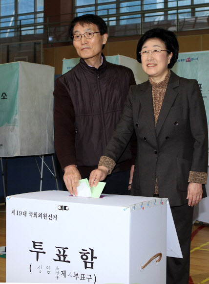민주통합당 한명숙 대표가 제19대 국회의원 선거일인 11일 오전 서울 마포구 상암중학교 체육관에 마련된 상암 제4투표소에서 남편 박성준 교수와 함께 투표를 하고 있다.