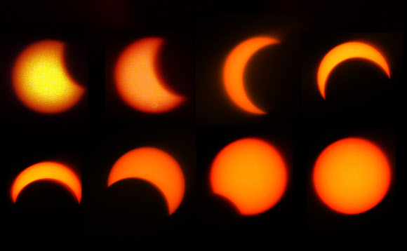 달이 태양을 가리는 부분일식이 진행된 21일 오전 서울 북악 스카이웨이에서 바라본 태양이 초승달 모양으로 변하고 있다. 이번 부분일식은 오전 6시23분부터 8시48분까지 진행됐으며 오전 7시 32분경에는 태양의 80%까지 가려졌다. 연합뉴스