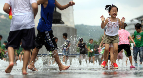 전국 대부분 지방 낮 최고 기온이 30도를 넘는 불볕더위가 이어진 24일 오후 서울 광화문 광장에서 어린이들이 물놀이하며 더위를 식히고 있다. 연합뉴스