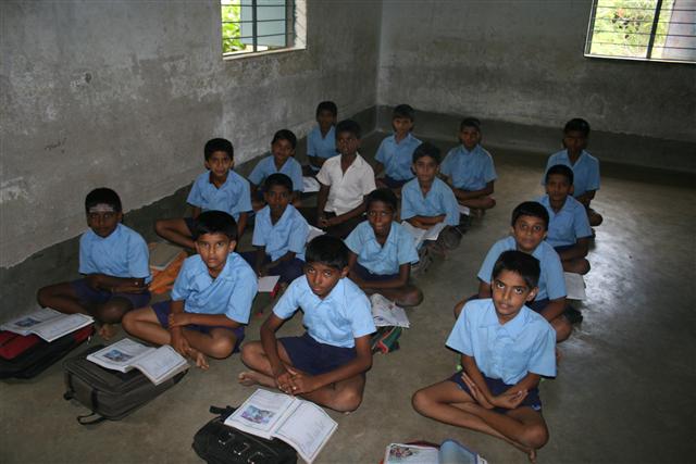 벵갈루루시 코디치카나할리 소재 공립 초등학교 학생들이 교실에 앉아 책가방 위에 교과서를 올려 놓은 채 수업을 듣고 있다.