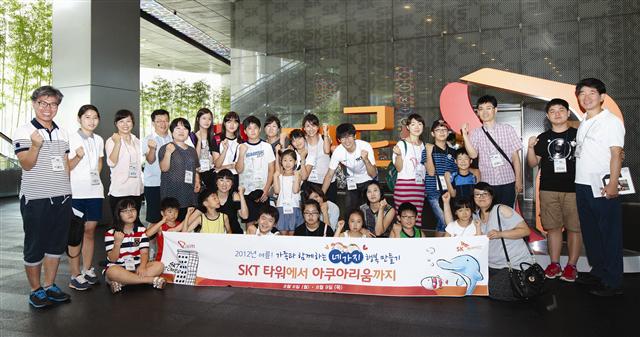 지난 6일 서울 중구 을지로 SK텔레콤 본사에서 ‘가족과 함께하는 행복 만들기’ 행사에 참가한 SK하이닉스 임직원과 가족들이 티움관 방문에 앞서 기념촬영을 하고 있다.  SK하이닉스 제공