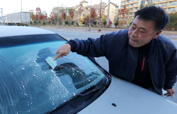 15일 강원 평창군 대관령 지역의 최저기온이 올해 가을 들어 가장 낮은 영하 1도까지 떨어졌다. 대관령 지역의 주민들이 차창에 얼어붙은 얼음을 제거하고 있다. 연합뉴스