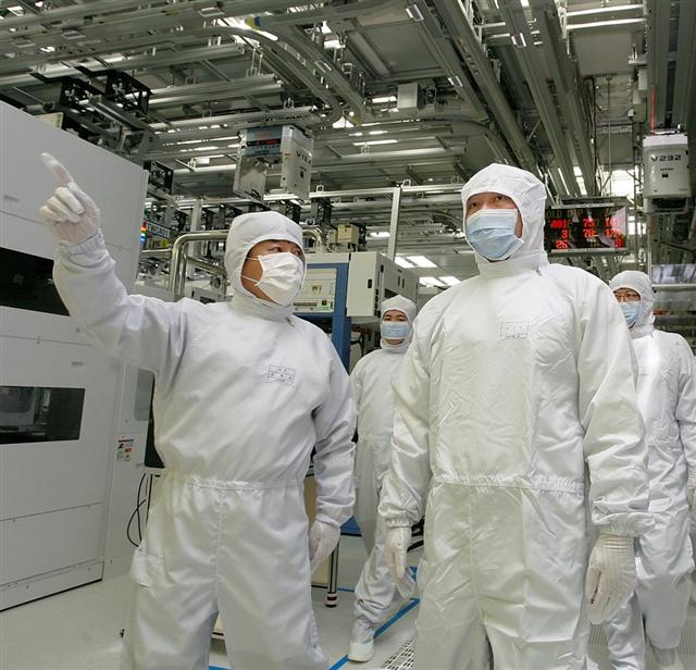 SK하이닉스 청주 공장에서 낸드플래시 생산라인을 둘러보고 있는 최태원(오른쪽) 회장. SK그룹은 반도체를 새로운 성장 엔진으로 삼고 있다.  SK그룹 제공