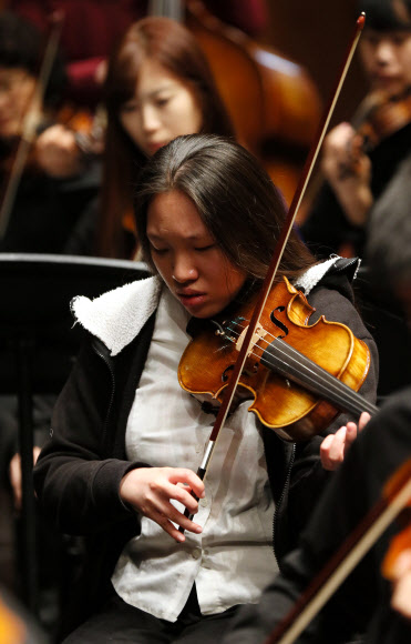 시각장애 특수학교인 인천혜광학교의 한 학생이 14일 오전 인천시 남동구 인천종합문화예술회관에서 열리는 연주회를 앞두고 바이올린을 켜며 예행연습을 하고 있다. 연합뉴스