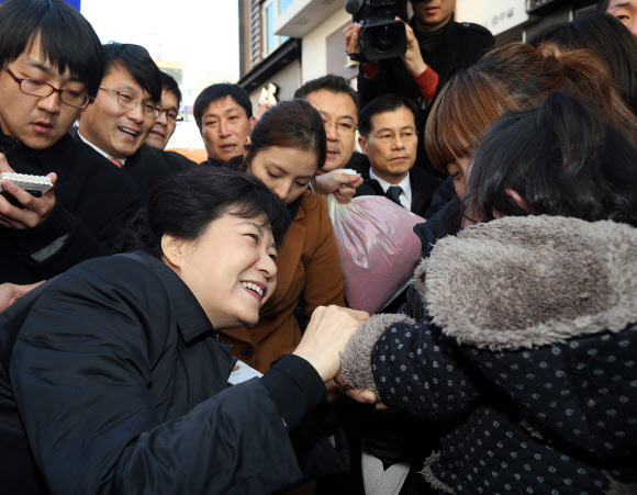 새누리당 박근혜 대선후보가 14일 오후 충북 충주시 성서동 차없는 거리를 걸으며 우는 아기를 달래고 있다. 연합뉴스