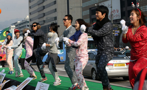 22일 오전 광화문 거리에서 새마을운동중앙회가 개최한 ‘겨울철 온(溫) 맵시 및 전기 20% 절약실천캠페인’에 참가한 대학생들이 내복을 입고 말춤을 추며 겨울철 내복입기 생활화를 통한 에너지 절약 실천을 호소하고 있다. 연합뉴스