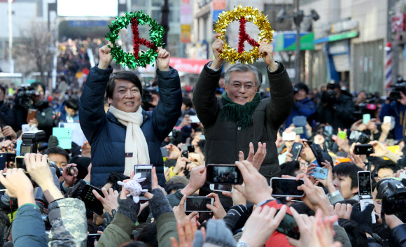 민주통합당 문재인 대선후보와 안철수 전 후보가 9일 경기도 군포시 산본역 앞에서 열린 집중유세에서 유권자에게 투표참여를 촉구하고 있다.  연합뉴스