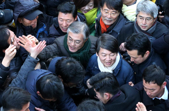 민주통합당 문재인 대선후보와 안철수 전 후보가 9일 경기도 군포시 산본역 앞에서 열린 집중유세에서 시민들과 인사를 나누고 있다. 연합뉴스