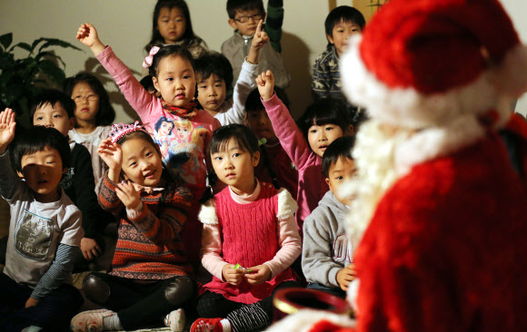 13일 오전 서울 은평구 배화유치원을 찾은 서울시 유아교육진흥원 ‘찾아가는 산타’가 어린이들에게 선물을 주고 있다. 연합뉴스