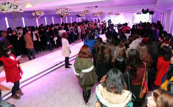 솔로대첩이 열린 24일 오후 광주 서구 치평동의 한 웨딩홀에서 솔로대첩에 참가한 남여가 나뉘어 선채 솔로대첩 행사를 하고 있다. 광주지역은 강추위를 고려해 실내에서 선착순 참석자를 대상으로 솔로대첩을 진행하기로 했다. 연합뉴스