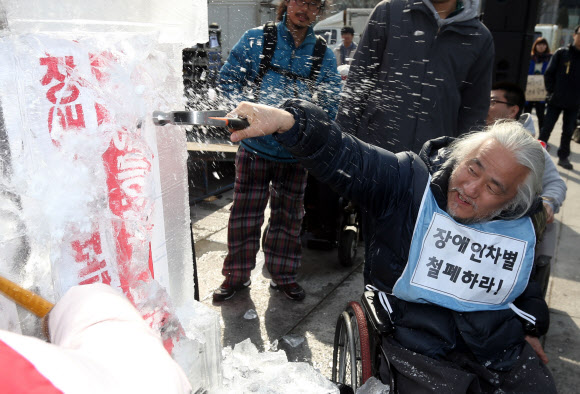 26일 오후 서울 광화문광장에서 열린 제9회 전국장애인대회에서 참석자들이 얼음을 깨는 퍼포먼스를 하고 있다. 연합뉴스