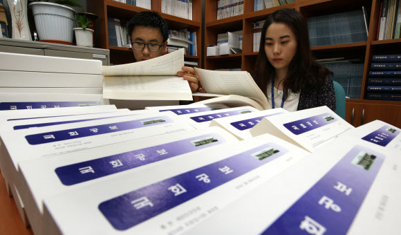 국회 공직자윤리위원회가 29일 고위공직직자들의 재산변동 신고 내역을 공개한 가운데, 여의도 국회에서 국회 사무처 직원들이 19대 국회의원의 재산공개 내역이 담긴 국회공보를 살펴보고 있다. 연합뉴스