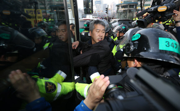 서울 중구청이 4일 새벽 덕수궁 대한문 앞에서 농성 중이던 쌍용차 해고노동자들의 천막을 기습 철거한 가운데 한 범대위 관계자가 경찰에 연행되며 강하게 저항하고 있다.  연합뉴스