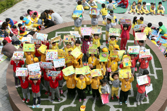 2일 오전 서울 광진구 뚝섬유원지에서 열린 ‘어린이 미술경연대회’에서 자양4동 어린이집 원아들이 자신의 그림을 뽐내고 있다. 연합뉴스