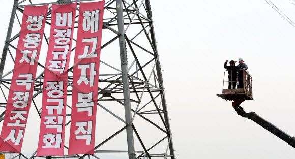 9일 오전 지난해 11월 20일부터 쌍용자동차 정리해고에 관한 국정조사와 해고자 복직 등을 요구하며 쌍용차 평택공장 인근 송전탑에 올라 농성을 벌여온 금속노조 쌍용차지부 한상균 전 지부장과 복기성 비정규직 수석부지회장이 농성을 풀고 송전탑에서 내려오고 있다. 사진은 한상균 전 지부장이 내려오며 구호를 외치는 모습. 연합뉴스