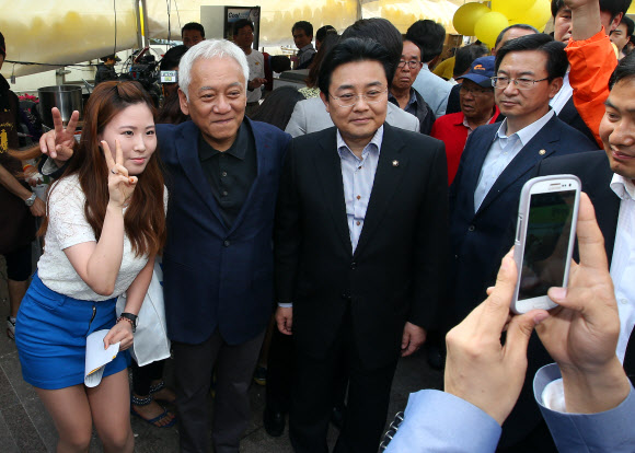 김한길 민주당 대표(가운데)와 전병헌 민주당 원내대표(오른쪽)가 19일 오후 노무현재단 주최로 서울광장에서 열린 ‘노무현 대통령 서거 4주기 서울광장 추모문화제’에 참석해 지지자와 사진을 찍고 있다.  연합뉴스