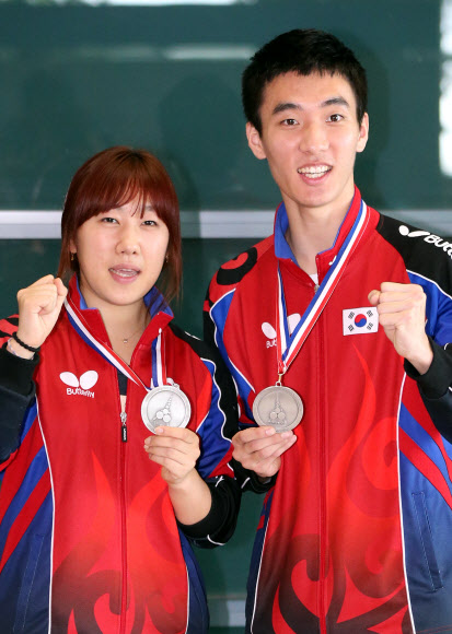 탁구세계선수권대회 혼합복식에서 은메달을 획득한 이상수과 박영숙이 22일 인천국제공항을 통해 귀국, 메달을 들고 포즈를 취하고 있다.   연합뉴스