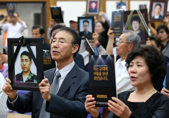 군 의문사 희생자의 유족들이 24일 오전 국회 의원회관에서 열린 ‘군 의문사 유족이 외치는 대 국회, 국민 호소 대회’에서 아들의 영정을 들고 진상규명과 명예회복을 촉구하고 있다.