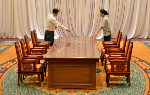 12~13일 서울에서 개최되는 남북당국회담을 하루 앞둔 11일 회담장소인 서울 홍은동 그랜드힐튼 호텔에 마련된 메인 회담장에서 호텔 관계자들이 양측 대표단이 앉을 자리에 대해 논의 하고 있다. 손형준 boltagoo@seoul.co.kr