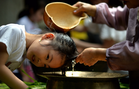 단오날인 13일 오전 서울 국립민속박물관에서 열린 단오풍속체험행사에서 어린이들이 창포물에 머리감기를 체험하고 있다. 박지환 popocar@seoul.co.kr
