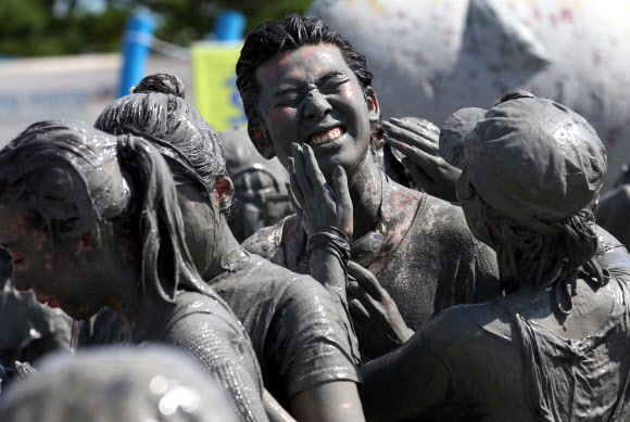 ‘제16회 보령머드축제’가 19일 충남 보령시 신흑동 대천해수욕장에서 개막식을 하고 10일간의 일정에 들어갔다. 축제장을 찾은 관광객들이 머드를 온몸에 흠뻑 바르고 즐거운 시간을 보내고 있다. 연합뉴스