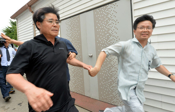 고교생 5명이 숨진 충남 태안군 안면도 ‘사설 해병대 캠프 사고’와 관련 21일 오전 이상규    공주사대부고 교장이 유가족을 피해 달아나고 있다. 연합뉴스