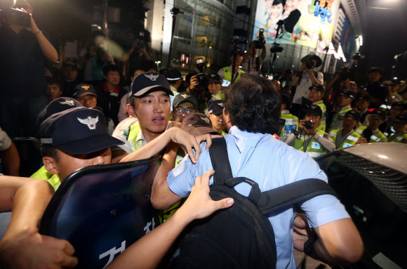 24일 오후 서울 청계광장 인근에서 광화문 광장으로 향하던 쌍용차 국정조사 촉구 범국민대회 참석자들이 경찰이 길을 막자 몸싸움을 벌이고 있다. 연합뉴스