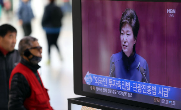 18일 오전 서울역에서 시민이 박근혜 대통령의 취임 후 첫 예산안 시정연설 방송을 지켜보고 있다. 연합뉴스