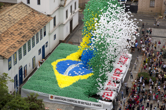 30일(현지시간) 브라질 상파울루 시내에서 열린 새해맞이 행사에서 국기 모양으로 장식된 풍선들이 하늘로 날아오르고 있다.  AP 연합뉴스