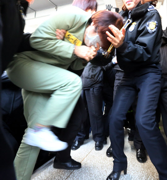 7일 울산지방법원에서 의붓딸을 때려 숨지게 한 계모 박모씨가 수의를 입은 채 재판장으로 서둘러 들어가고 있다. 연합뉴스