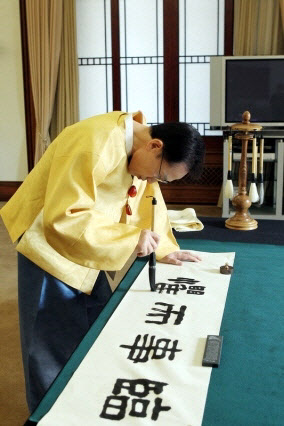 지난 2012년 이명박 대통령이 신년휘호를 쓰는 모습. 이 대통령은 ’여러운 시기, 큰일에 임하여 엄중한 마음으로 신중하고 치밀하게 지혜를 모아 일을 잘 성사시킨다’는 뜻으로 임사이구(臨事而懼)라는 휘호를 쓰고 있다.