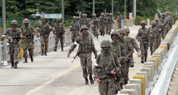 전날 동부전선 최전방 GOP에서 병사의 총기난사사건이 발생한 강원도 고성 일대에 서 22일 군 장병들이 무장한 채 수색작업을 펼치고 있다. 정연호 기자 tpgod@seoul.co.kr