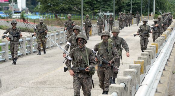 무장한 군 장병들이 22일 강원 고성군 일대에서 총기 난사 후 탈영한 임모 병장을 찾기 위해 대대적인 수색 작업을 펼치고 있다. 고성 정연호 기자 tpgod@seoul.co.kr