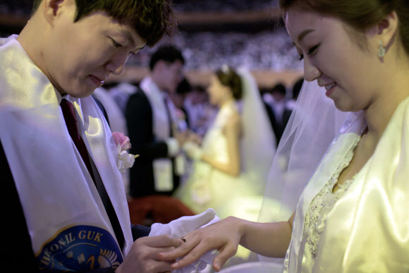 결혼 반지를 끼워주는 신랑 박현성 군. ⓒAFPBBNews=News1