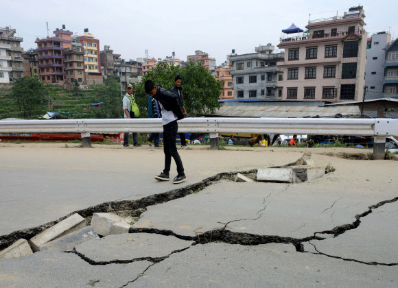 네팔 수도 카트만두에서 강진이 일어난 지 하루가 지난 26일 구조 대원이 무너져버린 도로를 살펴보고 있다. 25일 발생한 규모 7.8의 강진으로 네팔인 수천명이 사망했다. ⓒAFPBBNew=News1