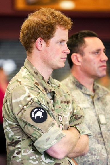 Britain’s Prince Harry (L) watches a “kapa haka” group perform during a visit to Linton Military Camp in Linton, near Palmerston North, on May 13, 2015.