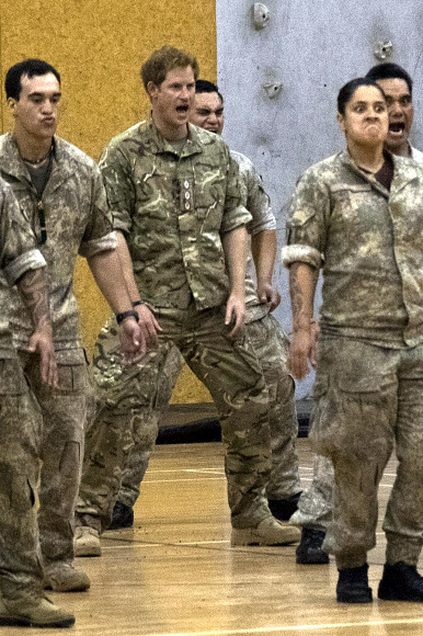 Britain’s Prince Harry (C) performs a “haka” with New Zealand Army personnel during his visit to Linton Military Camp in Linton, near Palmerston North, on May 13, 2015.