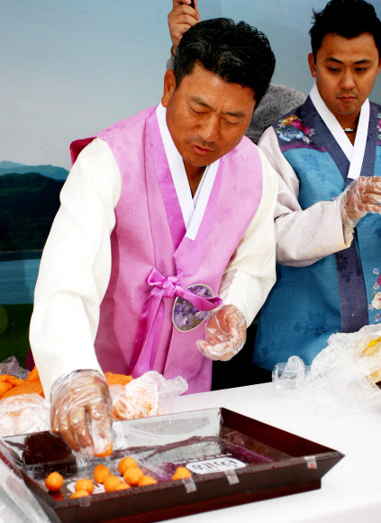 최경주가 19일 인천 영종도 스카이72GC 오션코스에서 열린 SK텔레콤 오픈 2015 공식포토콜에서 떡을 빚고 있다. 2015.5.19/ 연합뉴스