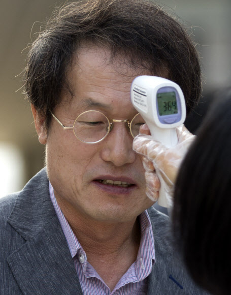 조희연 서울시교육감이 17일 오전 서울 중구 광희초등학교 정문에서 학교 관계자로부터 발열 검사를 받고 있다.  연합뉴스