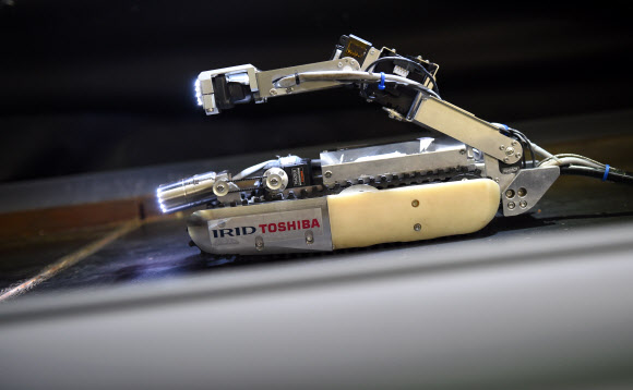 도시바와 IRID(International Research Institute for nuclear Decommissioning)가 개발한 소형 로봇을 30일(현지시간) 일본 요코하마의 도시바 공장에서 언론에 공개했다. 54센티미터 길이, 9센티미터 높이에 두 개의 CCD 카메라를 장착한 로봇은 원자로 격납 용기(PCV)를 조사하기 위해 제작됐다. ⓒ AFPBBNews=News1