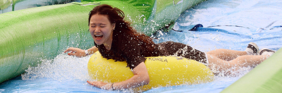 17일 서울 여의도 한강시민공원에서 시민들이 120m 길이의 워터슬라이드를 즐기고 있다. 박윤슬 기자 seul@seoul.co.kr