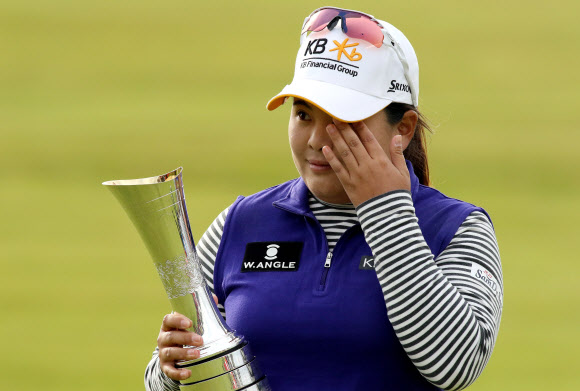 South Korea’s Park Inbee wipes away a tear as she celebrates her victory with the trophy after her final round 65, on day four of the Women’s British Open Golf Championships in Turnberry, Scotland, on August 2, 2015.