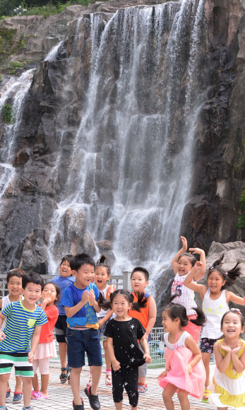 말복을 하루 앞둔 11일 중랑구 용마산로에 있는 용마산 폭포에서 주변 어린이집에서 더위를 피해 폭포구경을 온 아이들이 시원하게 쏟아져 내려오는 폭포수 풍경에 아이들이 즐거워하고 있다.  이언탁 기자 utl@seoul.co.kr