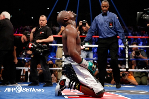 Floyd Mayweather Jr. kneels on the mat after winning his WBC/WBA welterweight title fight against Andre Berto at MGM Grand Garden Arena on September 12, 2015 in Las Vegas, Nevada. Mayweather won the fight by unanimous decision.  <br><br>