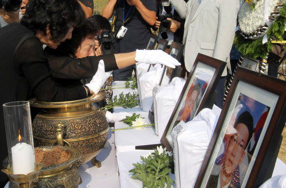 21일 대전 유성구 국립대전현충원 ‘제2연평해전 전사자 묘역’에서 유족이 영정 앞에서 눈물을 흘리고 있다.  국가보훈처는 유족 합의에 따라 그동안 나뉘어 안장돼 있었던 6용사의 합동묘역을 새로 조성했다. 연합뉴스