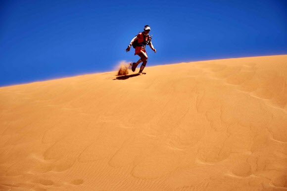 11일(현지시간) 열린 제31회 모로코 사하라 사막 마라톤 대회(MDS)에서 한 참가자가 모레 언덕을 뛰어 내려가고 있다.  AFP 연합뉴스