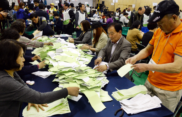 13일 저녁 종로구 청운동 경기상고에 마련된 개표소에서 개표요원들이 투표용지를 분류하고 있다.  강성남 선임기자 snk@seoul.co.kr